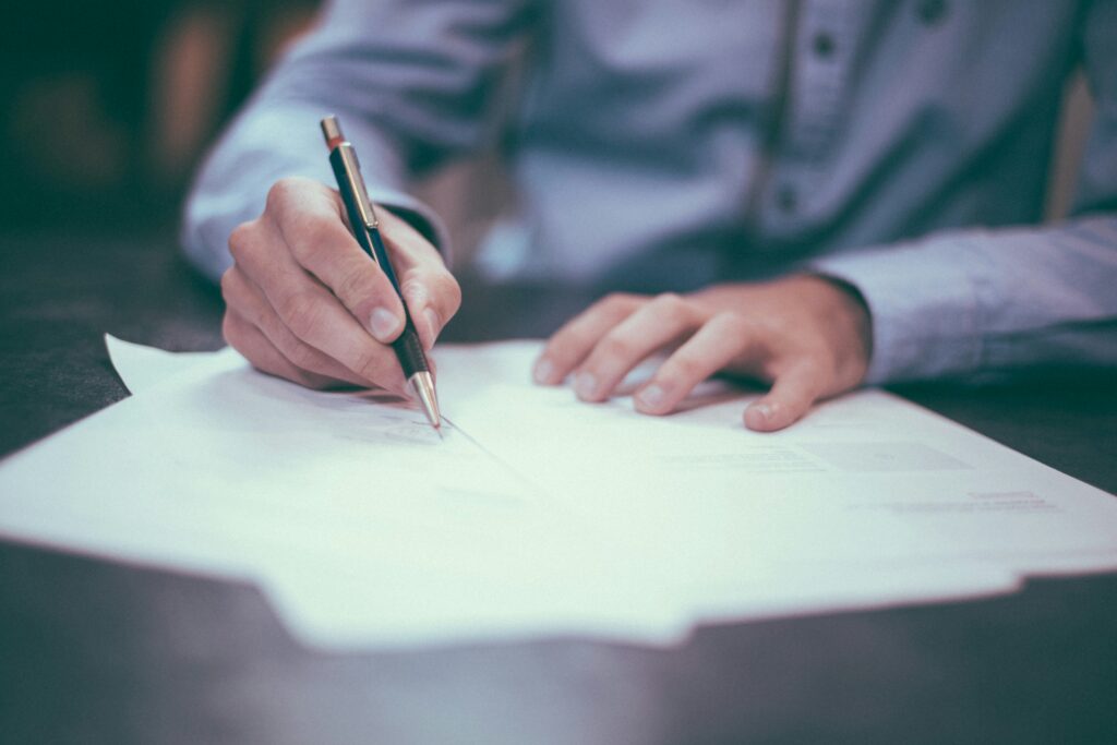 Image of a man filing out a form.