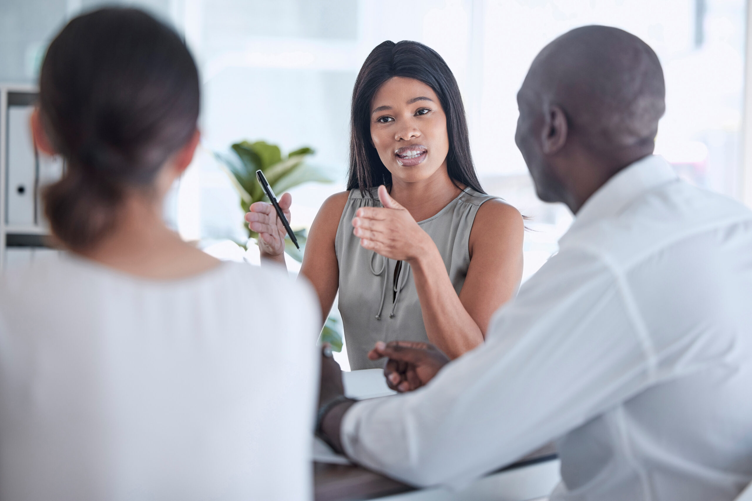 Two people sitting and speaking with a financial advisor.