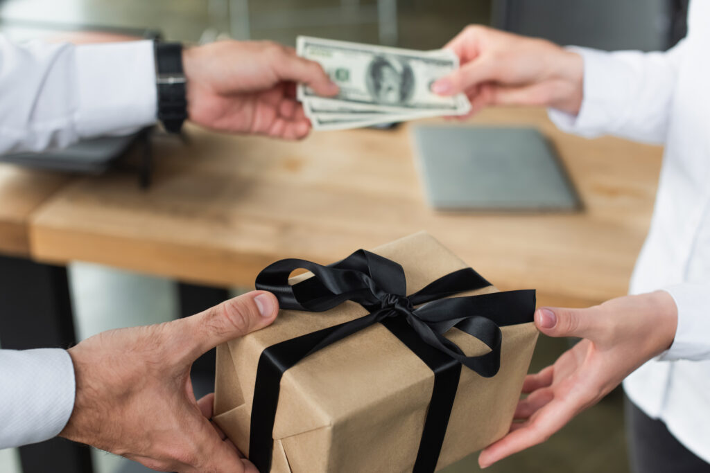 Man giving gift and cash to someone.