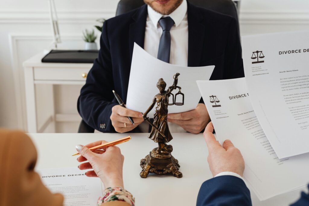 Couple signing divorce papers with a lawyer.